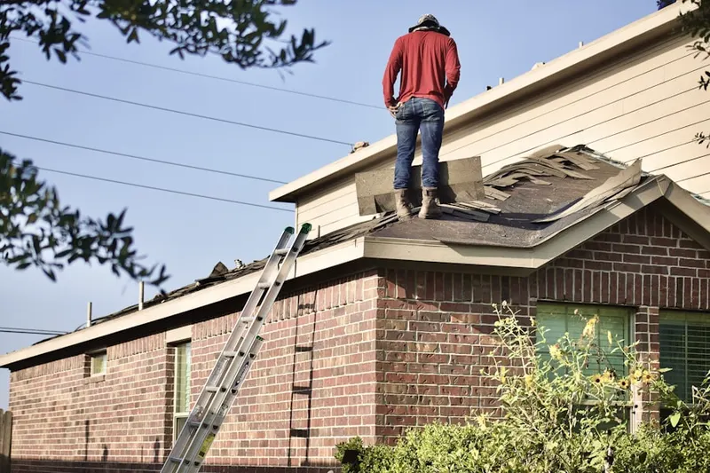 Professional roofer working on a residential roof in Mount Pleasant Housing